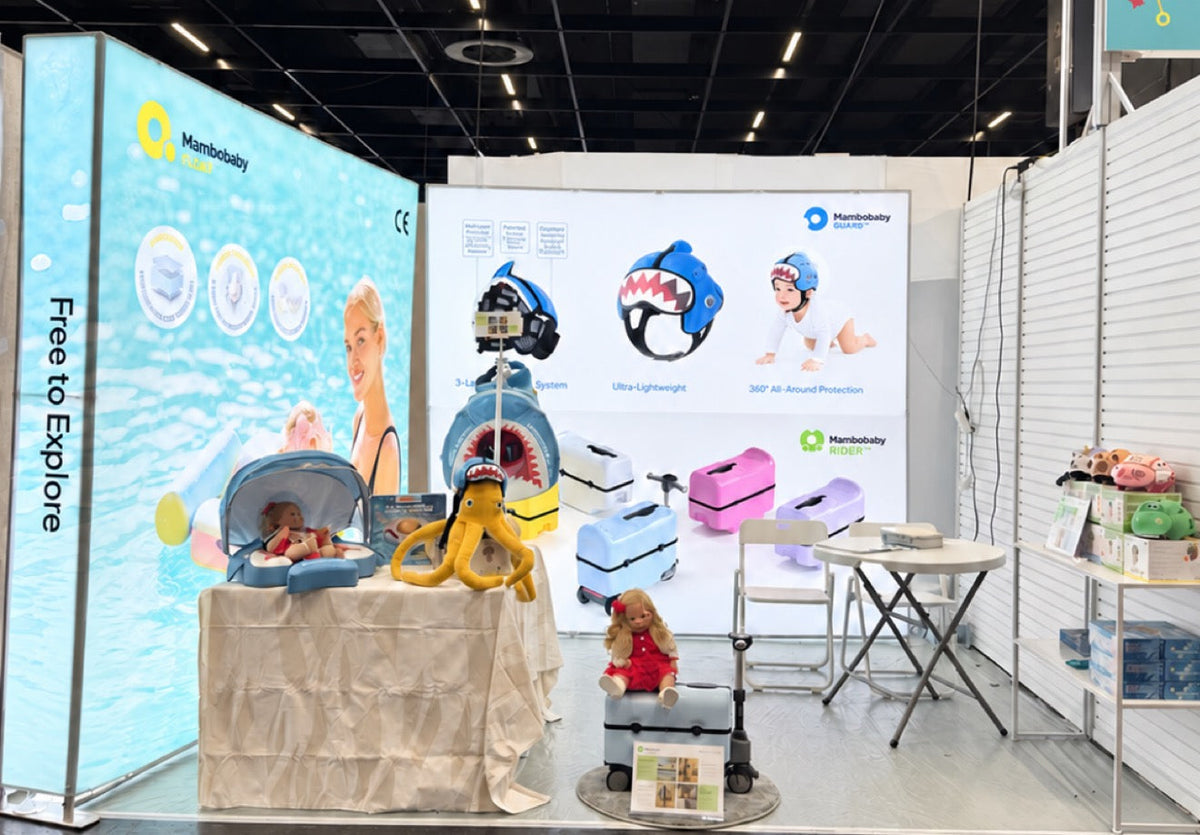 Mambobaby booth at Kind + Jugend 2026 in Cologne, displaying Float, Guard and Rider products.