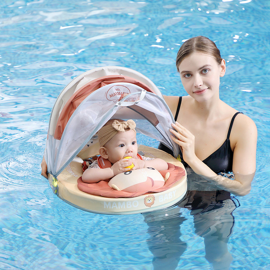 Woman holding a baby in a inflatable pool seat with canopy in a swimming pool.